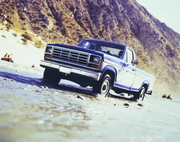 Blau-weißer 1985 Ford F-150 XL auf felsigem Untergrund